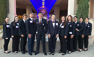 HOSA members pose in front of a fountain